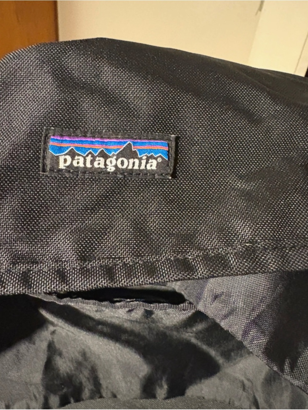Patagonia Black Backpack with Blue and Purple Logo Patch